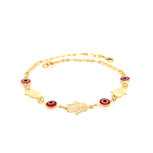 The Red Evil Eye Hamsa Hand Charm Anklet, crafted with 14k gold-filled mariner links, showcases hamsa hand charms and red evil eye motifs on a delicate chain, embodying spiritual protection against a crisp white background.
